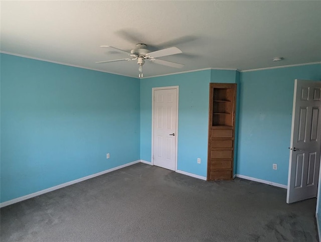 unfurnished bedroom featuring ceiling fan, crown molding, and dark carpet