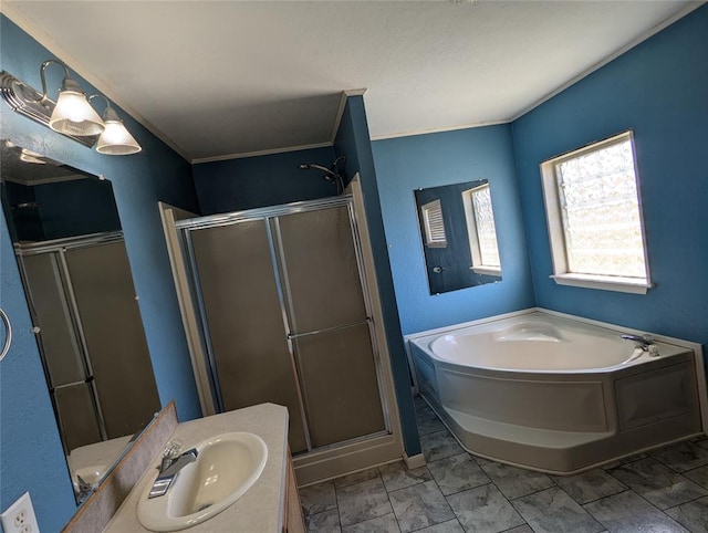 bathroom with crown molding, vanity, and shower with separate bathtub