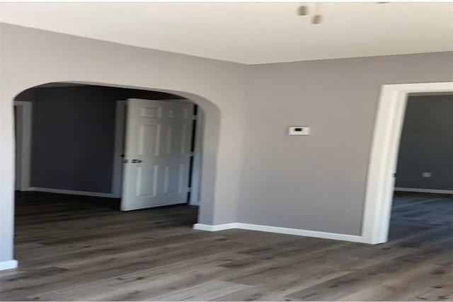 empty room featuring dark wood-type flooring