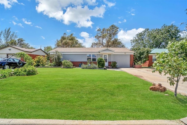 1033 Coe St, Altus, OK 73521 - ranch-style home featuring a front yard, concrete driveway, brick siding, and a shingled roof