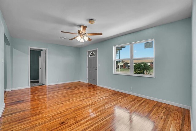 1033 Coe St, Altus, OK 73521 - unfurnished room with light wood-type flooring, baseboards, ceiling fan, and a smoke detector