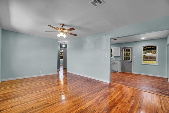 1033 Coe St, Altus, OK 73521 - spare room with hardwood / wood-style floors, a ceiling fan, and baseboards
