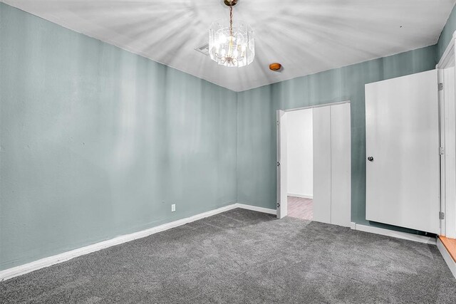 1033 Coe St, Altus, OK 73521 - unfurnished bedroom featuring carpet floors, a chandelier, and baseboards