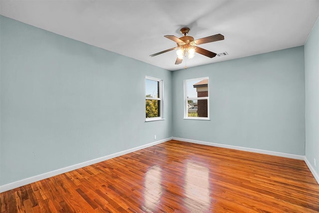 1033 Coe St, Altus, OK 73521 - spare room featuring wood finished floors, baseboards, and a ceiling fan