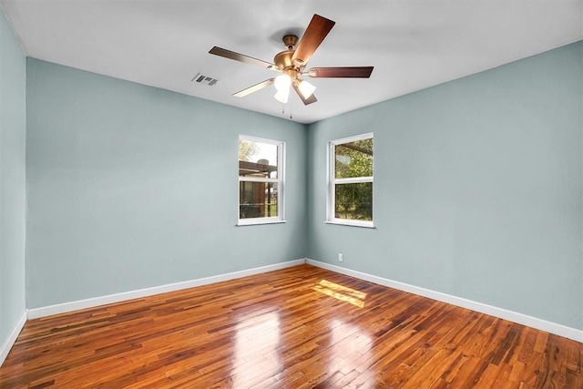 1033 Coe St, Altus, OK 73521 - unfurnished room featuring wood-type flooring, baseboards, and a ceiling fan
