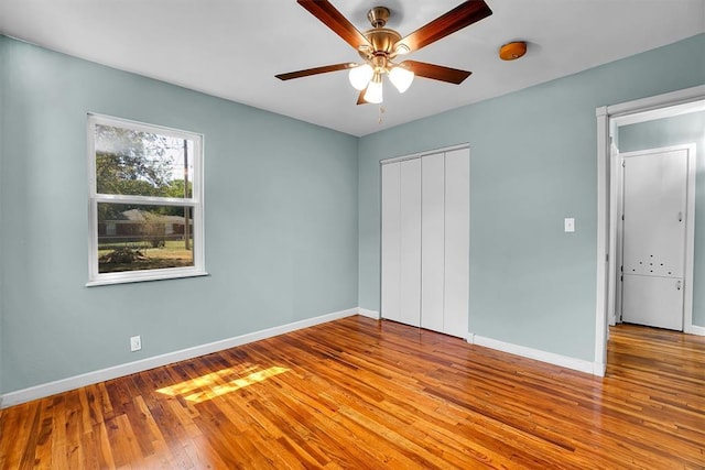 1033 Coe St, Altus, OK 73521 - unfurnished bedroom with hardwood / wood-style floors, baseboards, and a closet