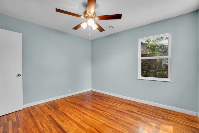 1033 Coe St, Altus, OK 73521 - spare room with wood finished floors, baseboards, and a ceiling fan