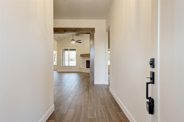 corridor featuring lofted ceiling with beams and wood-type flooring