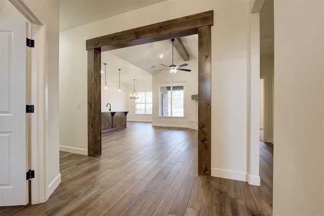 hallway featuring lofted ceiling with beams and dark hardwood / wood-style floors