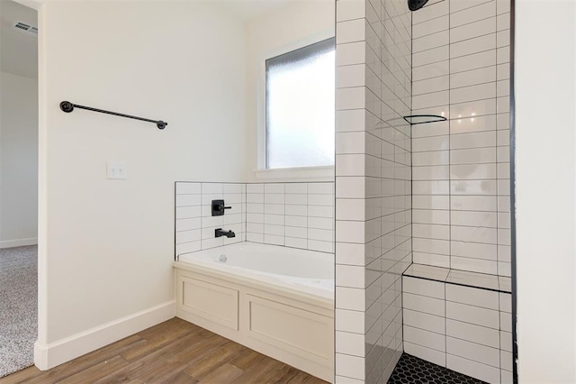 bathroom featuring wood-type flooring and independent shower and bath