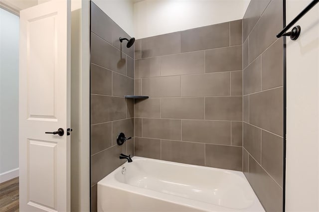 bathroom featuring hardwood / wood-style floors and tiled shower / bath combo