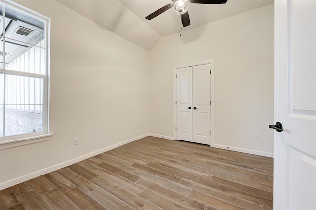 spare room featuring ceiling fan, light hardwood / wood-style flooring, and vaulted ceiling