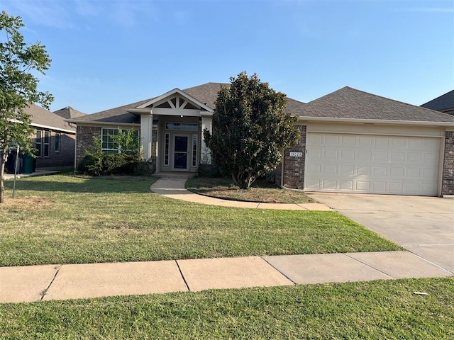 view of front of house featuring a garage and a front lawn