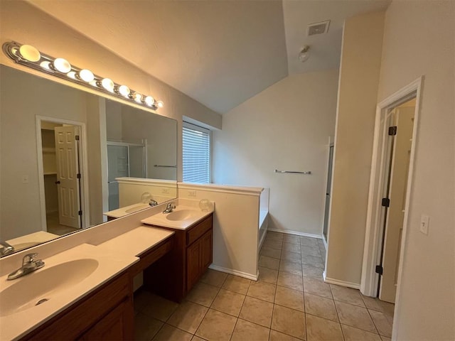 bathroom featuring tile patterned floors, separate shower and tub, vanity, and vaulted ceiling