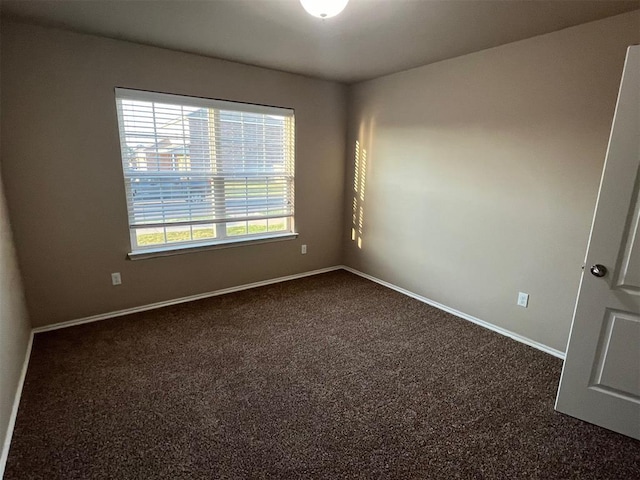 empty room with dark colored carpet