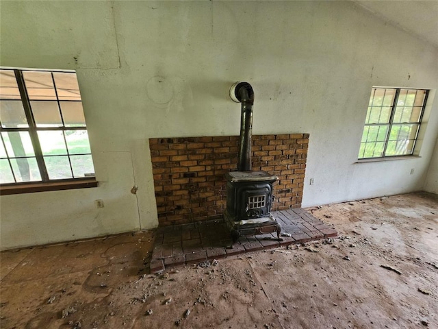 unfurnished living room featuring a wood stove