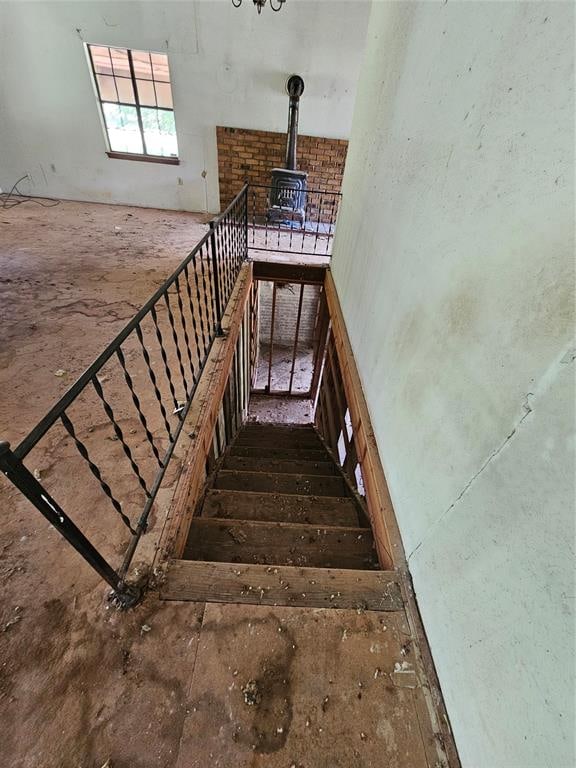 stairway featuring a wood stove