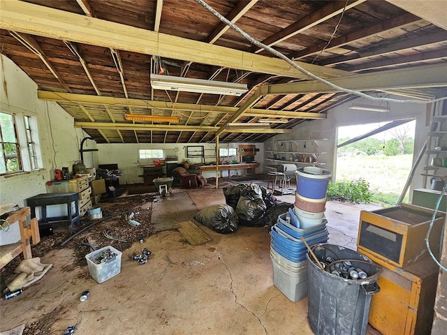 miscellaneous room featuring concrete flooring and lofted ceiling