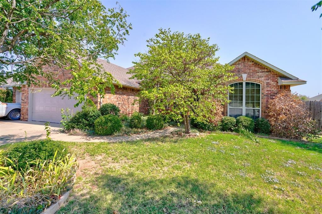 view of front of property with a front lawn and a garage