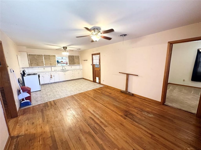 unfurnished living room featuring light hardwood / wood-style floors and ceiling fan