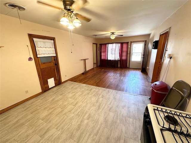 interior space with ceiling fan and light hardwood / wood-style flooring