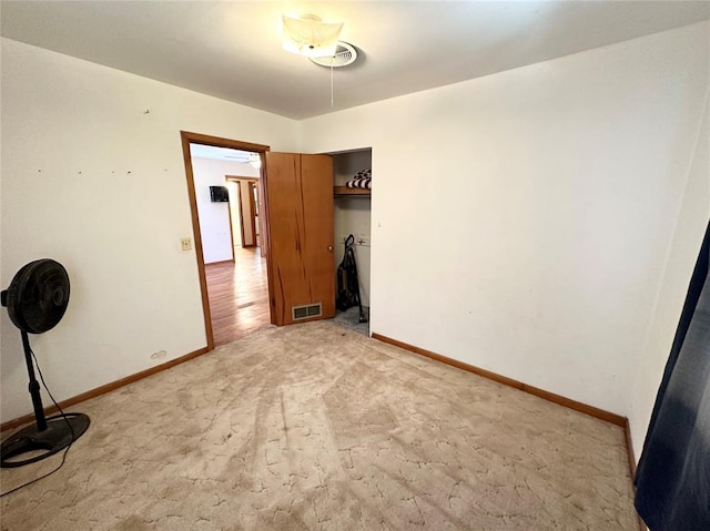 unfurnished bedroom featuring a closet and light wood-type flooring