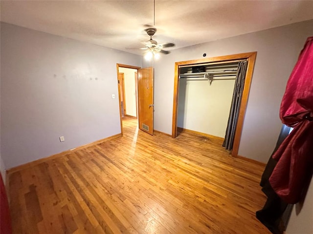 unfurnished bedroom with ceiling fan, a closet, and light hardwood / wood-style floors