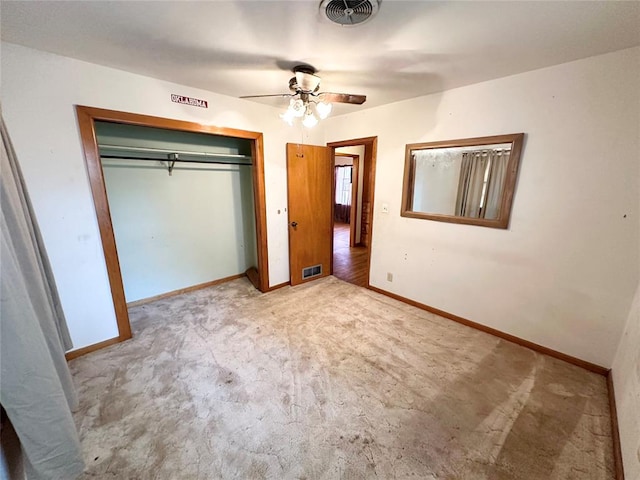 unfurnished bedroom with light carpet, a closet, and ceiling fan