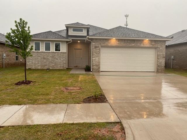 view of front facade with a front lawn and a garage