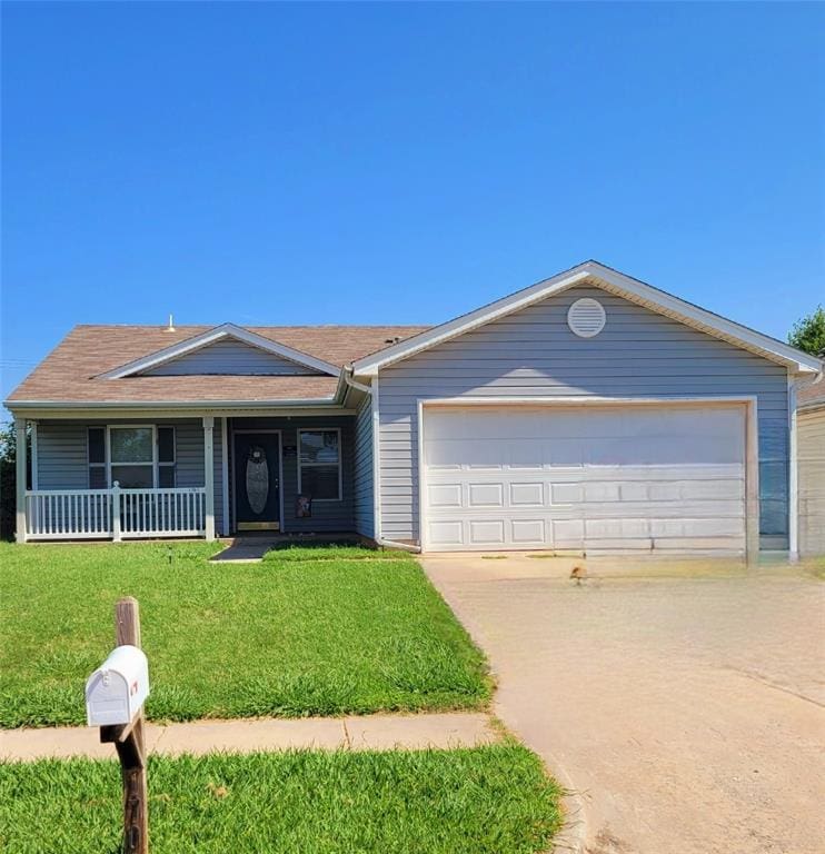 single story home with a front yard, a porch, and a garage