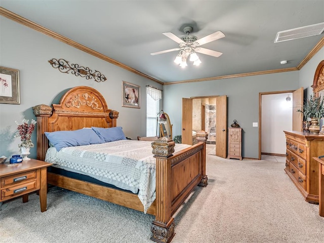 bedroom featuring ceiling fan, light colored carpet, ornamental molding, and ensuite bathroom