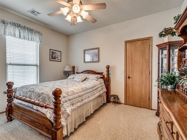 bedroom featuring light carpet and ceiling fan