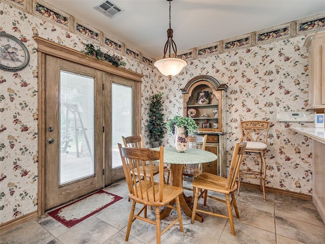 dining space featuring light tile patterned flooring