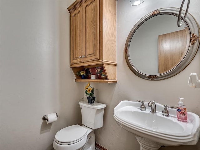 bathroom with toilet and sink