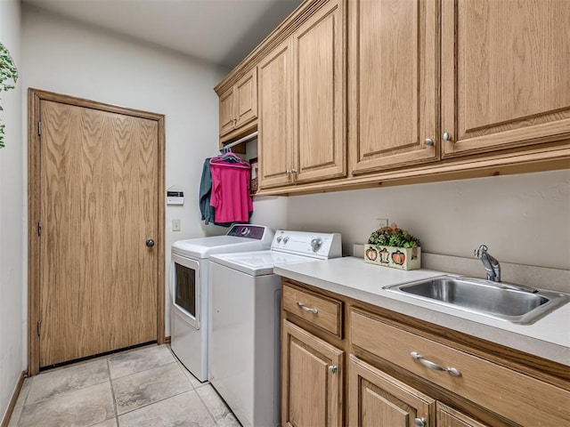 washroom with sink, cabinets, and independent washer and dryer