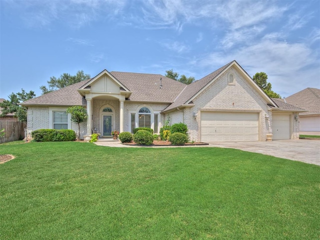 single story home featuring a front lawn and a garage