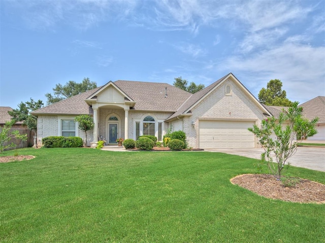 view of front of property with a garage and a front lawn