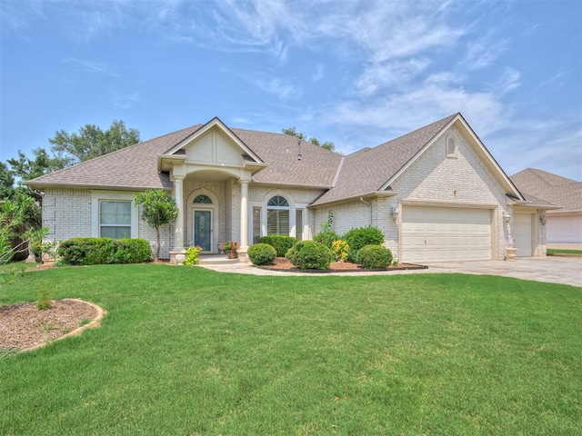 view of front of home with a garage and a front lawn