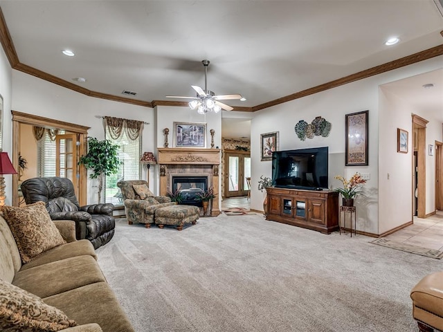 carpeted living room featuring ornamental molding and ceiling fan