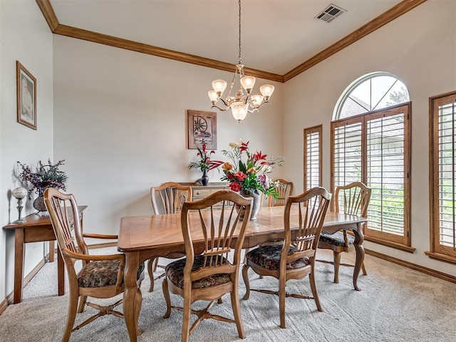 carpeted dining space with ornamental molding and an inviting chandelier