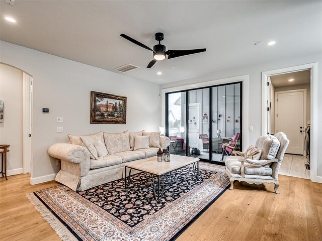 living room featuring ceiling fan and light wood-type flooring