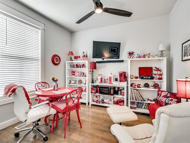 rec room with hardwood / wood-style floors and ceiling fan