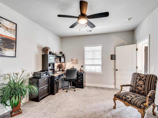 carpeted office with ceiling fan