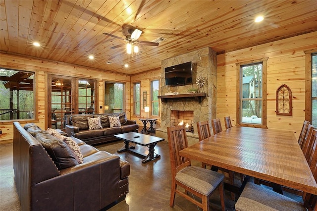 178 Black Jack Trl, Broken Bow, OK 74728 - living area featuring wooden ceiling, wood walls, finished concrete flooring, a ceiling fan, and plenty of natural light