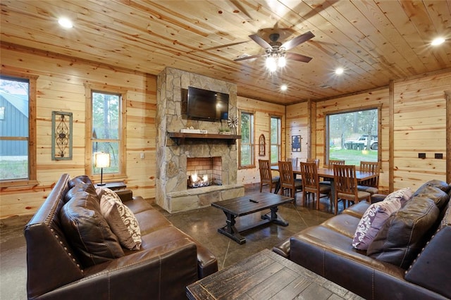 living room with wood walls, a fireplace, and wooden ceiling