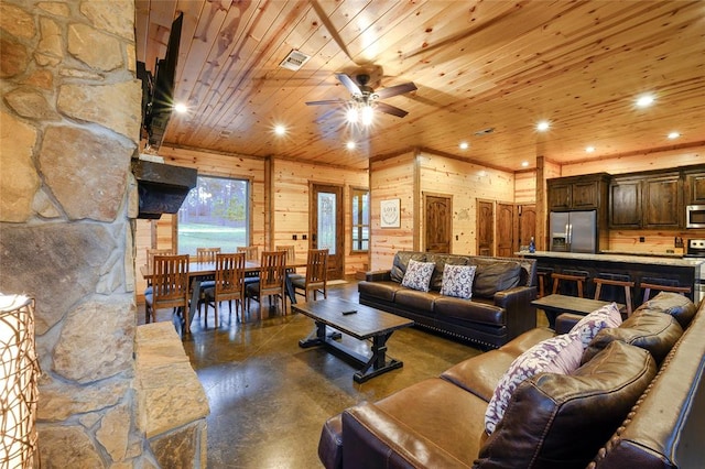 living room featuring wood walls, ceiling fan, and wood ceiling