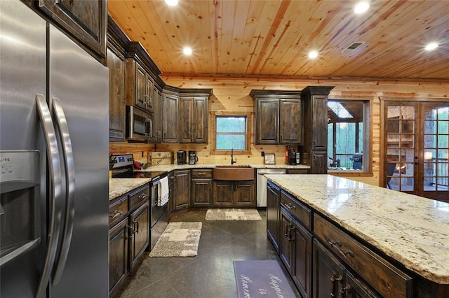 178 Black Jack Trl, Broken Bow, OK 74728 - kitchen with appliances with stainless steel finishes, recessed lighting, dark brown cabinetry, wood ceiling, and light stone counters