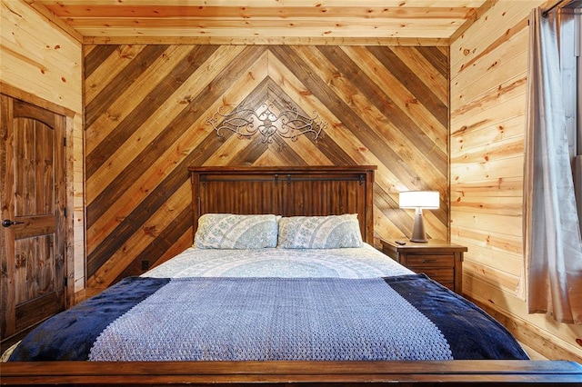 bedroom featuring wooden walls