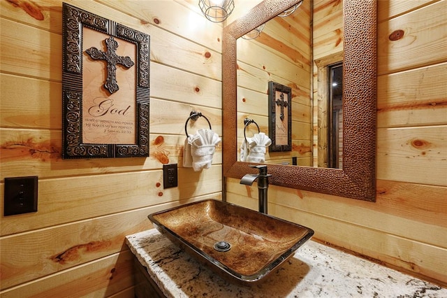 interior space with sink and wood walls