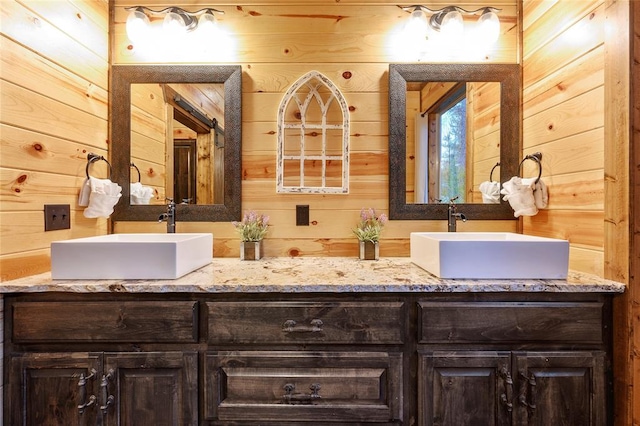 bathroom with vanity and wooden walls